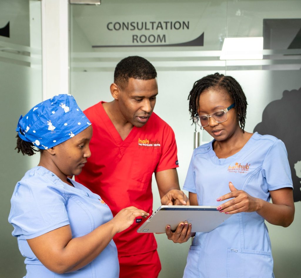 Hairhub trichologists reviewing a scalp analysis with a client in Nairobi